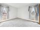 Bright bedroom with large windows and neutral carpet at 11285 Ranch Pl, Denver, CO 80234