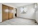 Bedroom with a window and closet with wood sliding doors at 11285 Ranch Pl, Denver, CO 80234