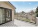 A large, spacious deck overlooks a landscaped yard with mature trees and sliding door access at 11285 Ranch Pl, Denver, CO 80234