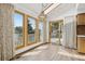 Inviting dining area with large windows, skylight, wood flooring, access to the deck, and stylish lighting at 11285 Ranch Pl, Denver, CO 80234