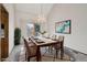 Dining area with modern chandelier and a sliding glass door to the outdoor balcony at 11285 Ranch Pl, Denver, CO 80234