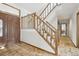 Entryway with tile floors, a staircase with wooden banister and front door at 11285 Ranch Pl, Denver, CO 80234