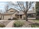 Charming two-story home with a well-manicured front yard, a brick pathway, and an attached garage at 11285 Ranch Pl, Denver, CO 80234