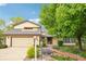 Charming home with a well-manicured lawn, mature trees, and inviting walkway at 11285 Ranch Pl, Denver, CO 80234
