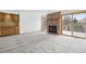 Living room features brick fireplace, neutral carpet, and built-in cabinets at 11285 Ranch Pl, Denver, CO 80234