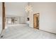 Open floor plan showcasing living room with fireplace, a large window, and neutral carpet at 11285 Ranch Pl, Denver, CO 80234