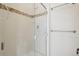 Tiled shower featuring glass door and decorative tile border at 11285 Ranch Pl, Denver, CO 80234