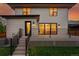 Back exterior view of home with deck, backyard, patio with black wrought iron railing, and sliding doors at 2391 Hudson St, Denver, CO 80207