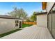 Well-maintained backyard featuring a spacious deck, a detached garage, and lush green lawn at 2391 Hudson St, Denver, CO 80207