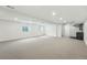 Large finished basement with neutral carpet, recessed lighting, and a wet bar area at 2391 Hudson St, Denver, CO 80207