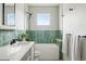 Well-lit bathroom with a modern tub, sleek vanity, stylish tile, and contemporary fixtures at 2391 Hudson St, Denver, CO 80207