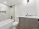 Modern bathroom featuring a bathtub, shower, and sleek vanity with matte black hardware at 2391 Hudson St, Denver, CO 80207