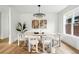 Bright dining room featuring modern chandelier, hardwood floors, and decorative artwork, providing an elegant setting at 2391 Hudson St, Denver, CO 80207