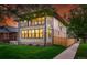 View of home's facade, manicured lawn, fenced yard, and the upper-level balcony with wrought iron railings at 2391 Hudson St, Denver, CO 80207
