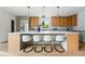 Modern kitchen featuring a large island with seating, stylish pendant lights, and a stainless steel refrigerator at 2391 Hudson St, Denver, CO 80207