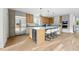 Modern kitchen features a large center island with seating, stylish cabinets, stainless steel refrigerator, and beverage center at 2391 Hudson St, Denver, CO 80207