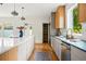 Contemporary kitchen with a spacious island, modern appliances, sleek countertops, and a view to the backyard at 2391 Hudson St, Denver, CO 80207