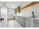 Spacious laundry room with modern cabinetry, long countertop, sink, and natural light at 2391 Hudson St, Denver, CO 80207