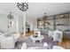 Open-concept living room featuring built-in shelving, stylish seating, and modern lighting fixtures at 2391 Hudson St, Denver, CO 80207