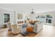 Bright living room with a modern fireplace, sliding glass doors, and hardwood floors at 2391 Hudson St, Denver, CO 80207