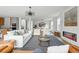 Inviting living room with a sleek fireplace, plush seating, designer lighting, and a chic area rug over hardwood floors at 2391 Hudson St, Denver, CO 80207