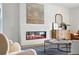 Close up of the contemporary fireplace, stylish console, and designer decor in the modern living room at 2391 Hudson St, Denver, CO 80207