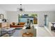 Bright living room showcasing modern furniture, a sliding glass door to the deck, and hardwood floors at 2391 Hudson St, Denver, CO 80207