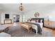 Spacious main bedroom with a decorative chandelier, accent rug, and ensuite bathroom at 2391 Hudson St, Denver, CO 80207