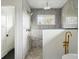 Modern walk-in shower with gray tile, rain shower head, and decorative accent wall at 2391 Hudson St, Denver, CO 80207