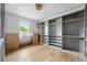 Large walk-in closet with custom shelves and drawers, window, and neutral color palette at 2391 Hudson St, Denver, CO 80207