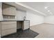 Basement wet bar featuring sleek cabinetry, stylish countertops, and modern fixtures at 2391 Hudson St, Denver, CO 80207