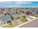 An aerial view showcases a residential neighborhood with well-maintained homes and green spaces on a sunny day at 56375 E 22Nd Pl, Strasburg, CO 80136