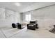 Basement area furnished with comfortable seating and a unique storage trunk at 56375 E 22Nd Pl, Strasburg, CO 80136