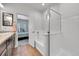 Well-lit bathroom featuring a tub and shower combo, stylish fixtures, and tiled walls at 56375 E 22Nd Pl, Strasburg, CO 80136