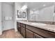 Elegant bathroom with double sinks, granite countertops, and a glass-enclosed shower at 56375 E 22Nd Pl, Strasburg, CO 80136