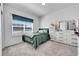 Bright bedroom featuring carpeted floors, a large window, and plenty of natural light at 56375 E 22Nd Pl, Strasburg, CO 80136