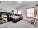 A decorated bedroom with a desk, chair and other accessories creating a workspace at 56375 E 22Nd Pl, Strasburg, CO 80136