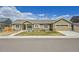 Single story home featuring a quaint front porch and a convenient two-car garage at 56375 E 22Nd Pl, Strasburg, CO 80136