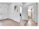 Hallway featuring neutral decor and access to a bathroom, bedroom, and other rooms throughout the home at 56375 E 22Nd Pl, Strasburg, CO 80136