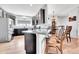 Kitchen with granite countertops, stainless steel appliances, dark cabinetry, and a view into the dining area at 56375 E 22Nd Pl, Strasburg, CO 80136