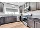 Stylish kitchen showcases dark cabinets, granite counters, and stainless steel appliances at 56375 E 22Nd Pl, Strasburg, CO 80136