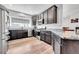 Spacious kitchen boasts stainless steel appliances, granite countertops, and dark cabinetry at 56375 E 22Nd Pl, Strasburg, CO 80136