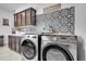 Well-lit laundry room features cabinets and decor at 56375 E 22Nd Pl, Strasburg, CO 80136