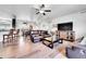 Bright living room features hardwood floors, a plush sofa, and seamless transition to the adjacent dining and kitchen areas at 56375 E 22Nd Pl, Strasburg, CO 80136