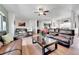 Spacious living room boasts hardwood floors, ample seating, a ceiling fan, and plenty of natural light at 56375 E 22Nd Pl, Strasburg, CO 80136