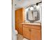 Cozy bathroom features wooden vanity, storage cabinet, a decorative mirror and ample lighting at 8060 E Girard Ave # 311, Denver, CO 80231
