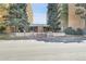 The building's facade has a tidy parking area, a neat brick entryway, and verdant bushes all around at 8060 E Girard Ave # 311, Denver, CO 80231