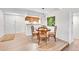 Open floor plan of dining and kitchen area, hardwood floors, white walls, recessed lights and dining set at 8060 E Girard Ave # 311, Denver, CO 80231