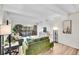 Bright living room with white ceilings, a stylish sofa, sleek wood floors, and sliding glass doors to a balcony at 8060 E Girard Ave # 311, Denver, CO 80231