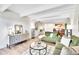 Bright living room with hardwood floors, green sofas, a round table, modern décor, and recessed lighting at 8060 E Girard Ave # 311, Denver, CO 80231